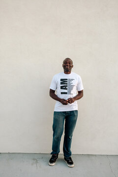 Tall smiling Black man in jeans and t-shirt