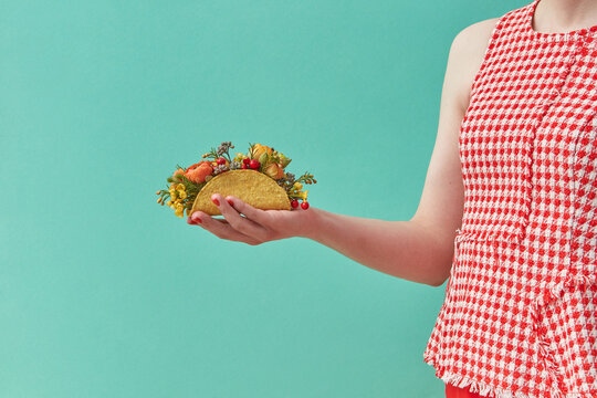 Woman holding taco with flowers