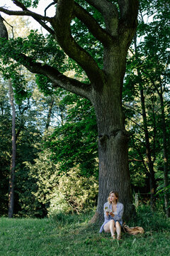 Female eating sandwich while sitting under tree during short local trip