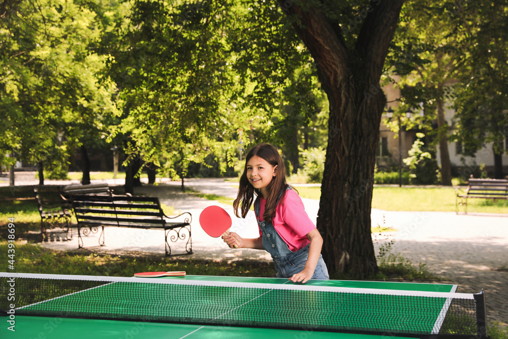 Sticker Little girl playing ping pong in park