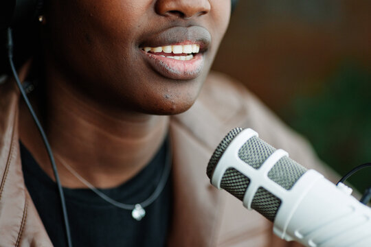 Anonymous person having speech into microphone 