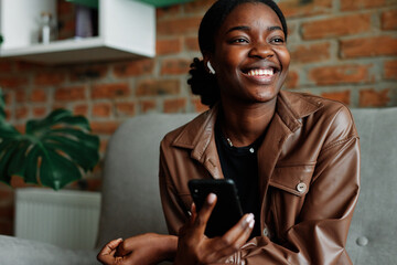 Female listener laughing at audio  story 