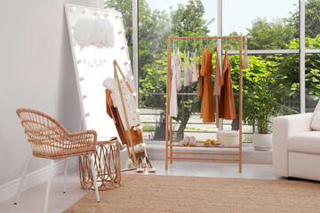 Dressing room interior with clothing rack and comfortable furniture