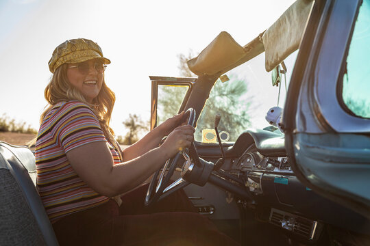 Young cool girl in summer  with yellow  hat in Vintage Car 