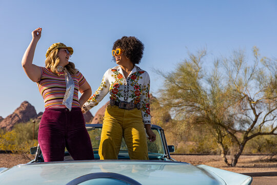Carefree Friends Dancing in  Car on road trip 