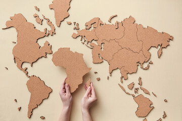 Woman putting African continent on map