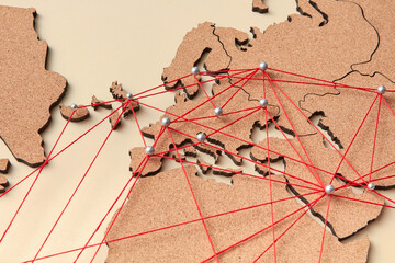Closeup of world map with red lines and pins