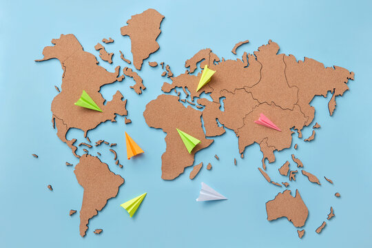 Colored paper planes on map