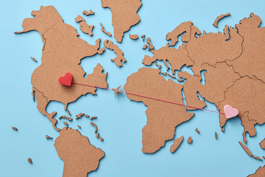 Plane flying between hearts on world map