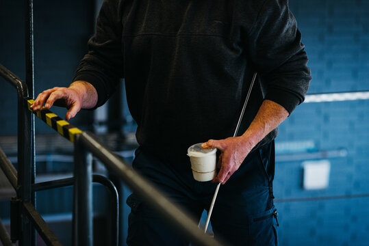 close up of a milk sample held by a man
