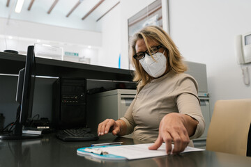 Working at the reception of a clinic.