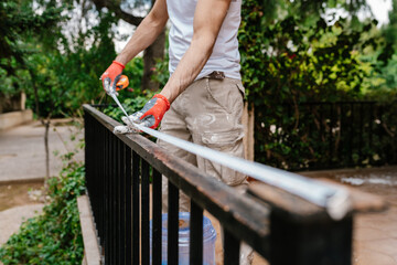 Anonymous bricklayer's hands on the exterior of a home