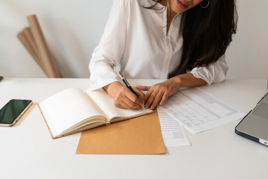 faceless Woman writing in her notebook