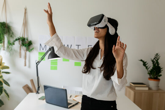 Young woman using virtual reality glasses