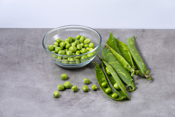 Bowl with fresh peas taken from their pods