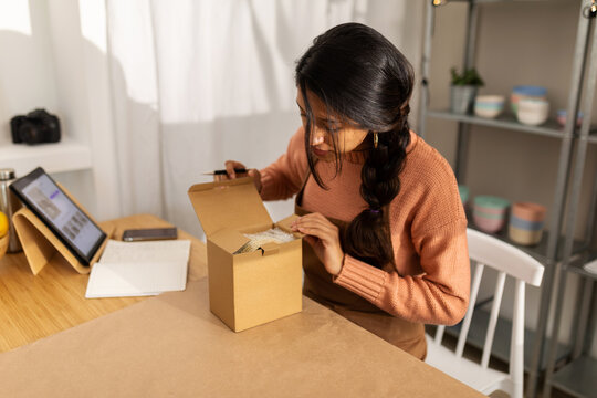 Detail of woman packing an ecological product at workplace
