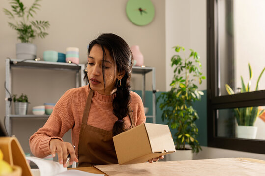Woman preparing an order at online store