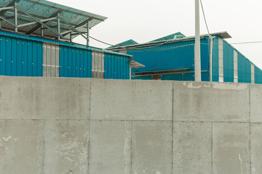 Concrete walls and blue roofs