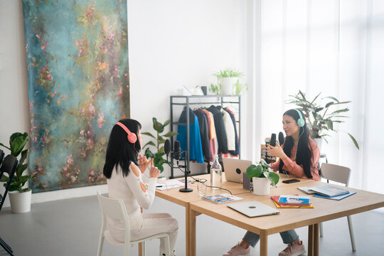 Female bloggers recording audio program in studio