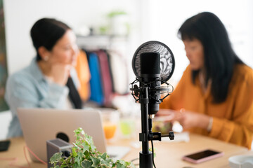 Microphone near women having lunch in recording studio