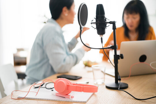 Audio equipment near women recording podcast