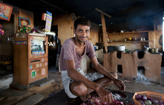 Cook making lunchtime dhal, Rajasthan, India