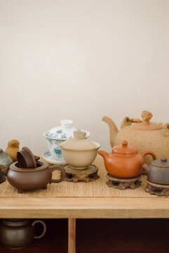 Commode with teapots and tea cups