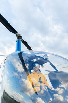 Helicopter pilot with sunglasses preparing to fly