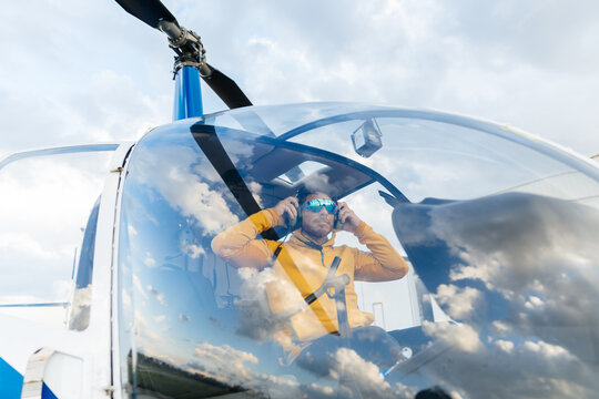Helicopter pilot with sunglasses preparing to fly