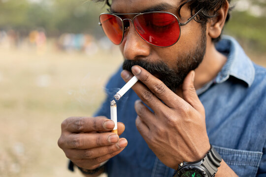 Indian man lighting cigarette