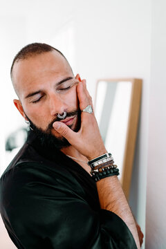 Portrait of moden man wiearing piercings an jewerly