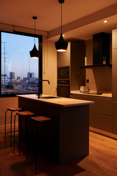 Modern kitchen of an apartment in the evening