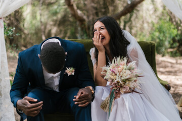 Happy bride and groom celebrating wedding in nature