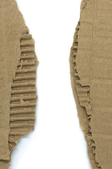 Brown torn cardboard isolated on white background close-up. To put on corners.