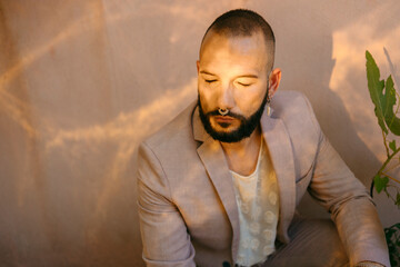 Male model posing outdoor with closed eyes