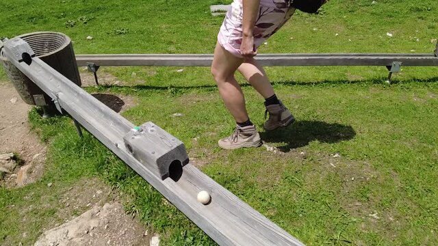 SLOW MOTION: Tourist girl playing marble run murmelibahn. In Parpaner Rothorn mount of Switzerland. Albula region in Grisons canton. slow motion