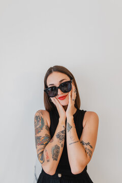 Portrait of woman with tattoos and sunglasses