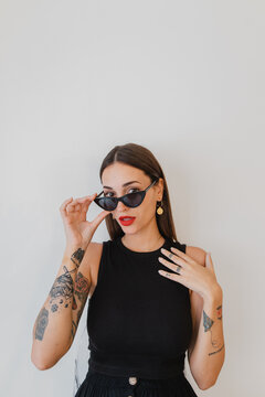 Portrait of woman with tattoos and sunglasses