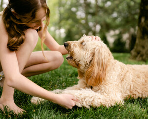 girl petting her puppy 
