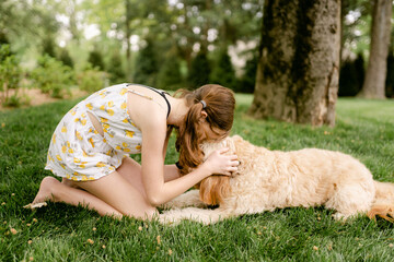 girl cuddling her dog