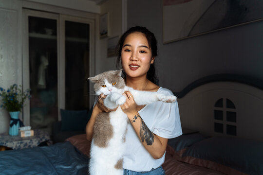 young girl playing with cat