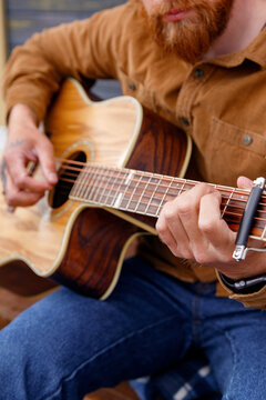 Anonymous guy playing song on acoustic guitar