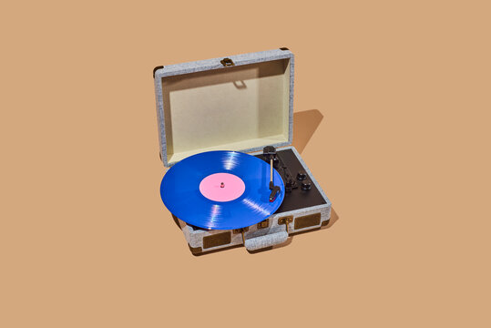 blue disc being played in a portable turntable