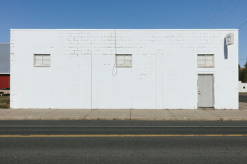 Minimalist white-washed building on street corner