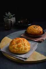 freshly baked Hong Kong Macau butter crispy skin polo bun in dark background pastry halal menu