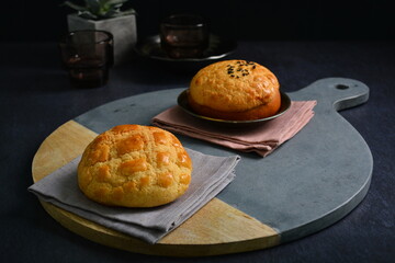 freshly baked Hong Kong Macau butter crispy skin polo bun in dark background pastry halal menu