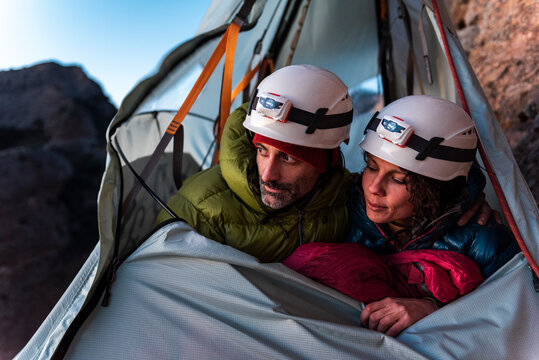Climbers with safety helmets inside a wall tent