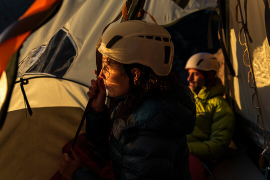Climbers resting inside a wall portaledge at mountain