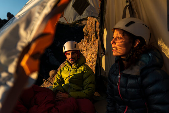 Climbers resting inside a wall portaledge at mountain
