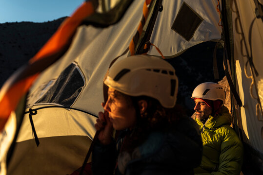 Climbers resting inside a wall portaledge at mountain